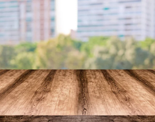 Wooden empty table board in front of blurred background. Can be used for display or montage any product. Mock up for display your product.