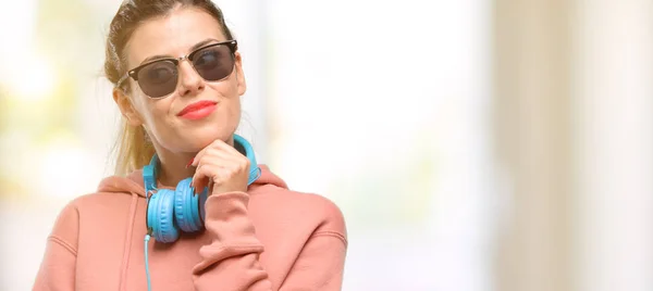 Młoda Kobieta Słuchawki Okulary Przeciwsłoneczne Wskazując Drogi Boczne Palca Sportu — Zdjęcie stockowe