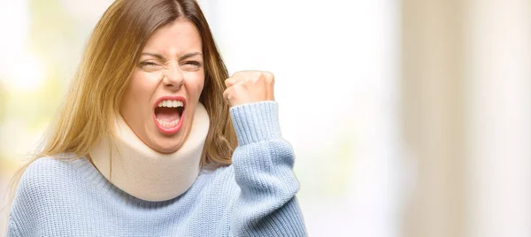 Young injured woman wearing neck brace collar irritated and angry expressing negative emotion, annoyed with someone