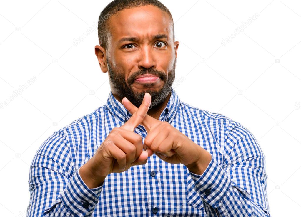 African american man with beard annoyed with bad attitude making stop sign with hand, saying no, expressing security, defense or restriction, maybe pushing isolated over white background