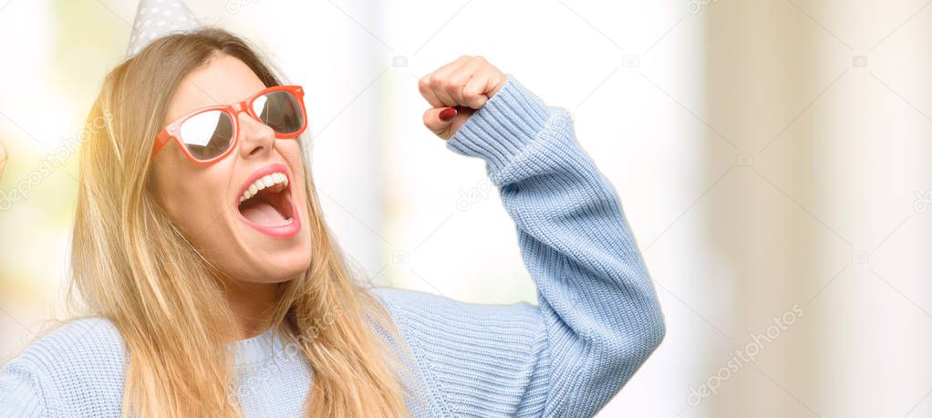 Young woman celebrates birthday happy and excited celebrating victory expressing big success, power, energy and positive emotions. Celebrates new job joyful