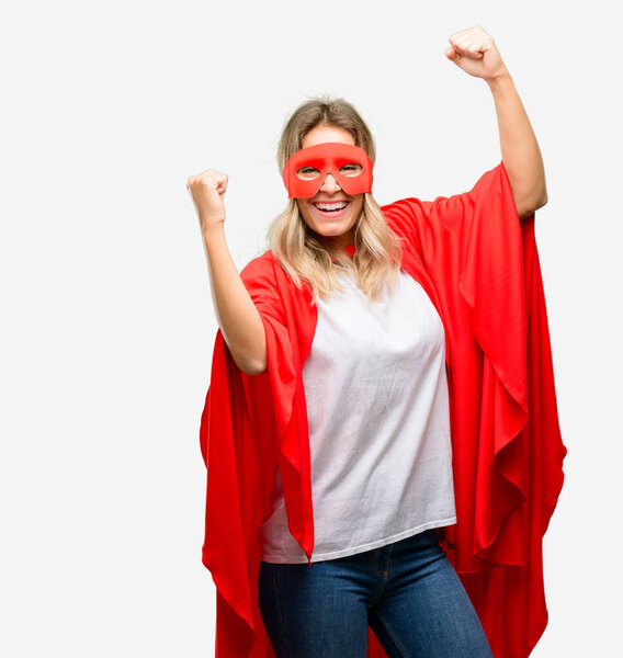 Young super hero woman wearing cape happy and excited celebrating victory expressing big success, power, energy and positive emotions. Celebrates new job joyful