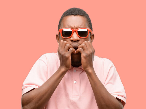 African black man wearing sunglasses terrified and nervous expressing anxiety and panic gesture, overwhelmed
