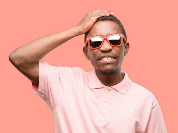 African black man wearing sunglasses terrified and nervous expressing anxiety and panic gesture, overwhelmed