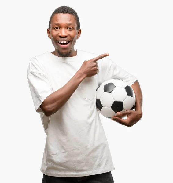 African Black Man Holding Soccer Ball Pointing Away Side Finger Royalty Free Stock Photos