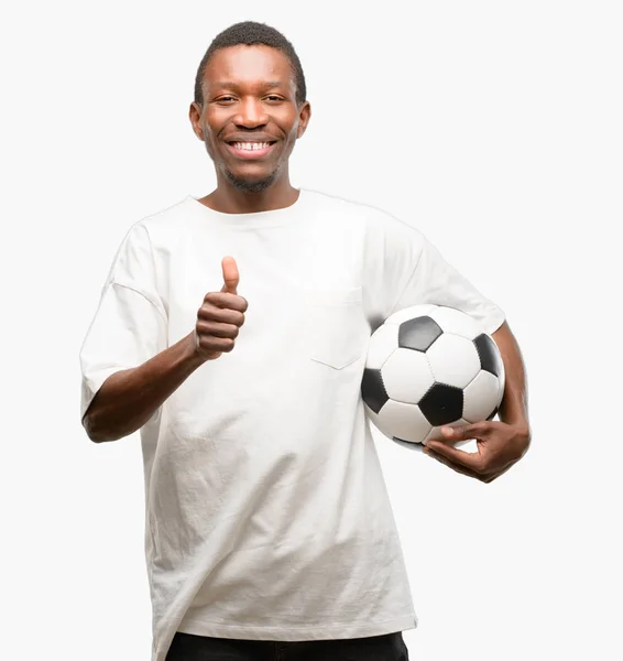 African Black Man Holding Soccer Ball Smiling Broadly Showing Thumbs Stock Picture