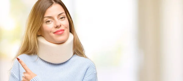 Young Injured Woman Wearing Neck Brace Collar Pointing Away Side — Stock Photo, Image