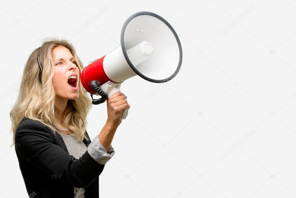 Young woman operator from call center communicates shouting loud holding a megaphone, expressing success and positive concept, idea for marketing or sales