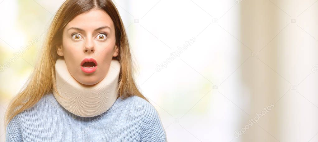 Young injured woman wearing neck brace collar scared in shock, expressing panic and fear