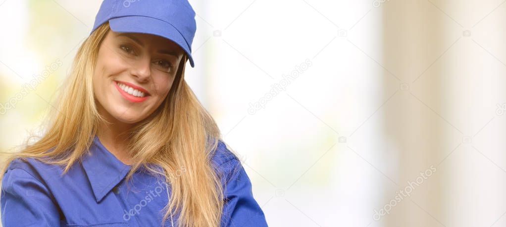 Young plumber woman with crossed arms confident and happy with a big natural smile laughing