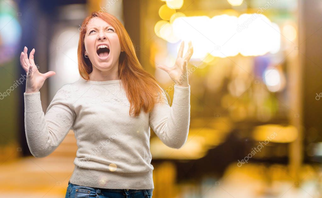 Beautiful young redhead woman terrified and nervous expressing anxiety and panic gesture, overwhelmed at night