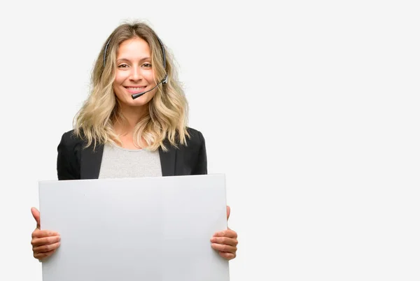 Young woman operator from call center holding blank advertising banner, good poster for ad, offer or announcement, big paper billboard