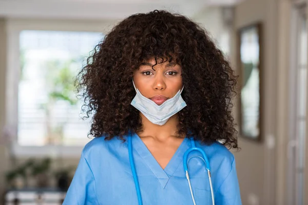 African american woman medical professional with a confident expression on smart face thinking serious