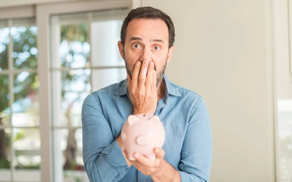 Middle Age Man Money Piggy Bank Cover Mouth Hand Shocked — Stock Photo, Image