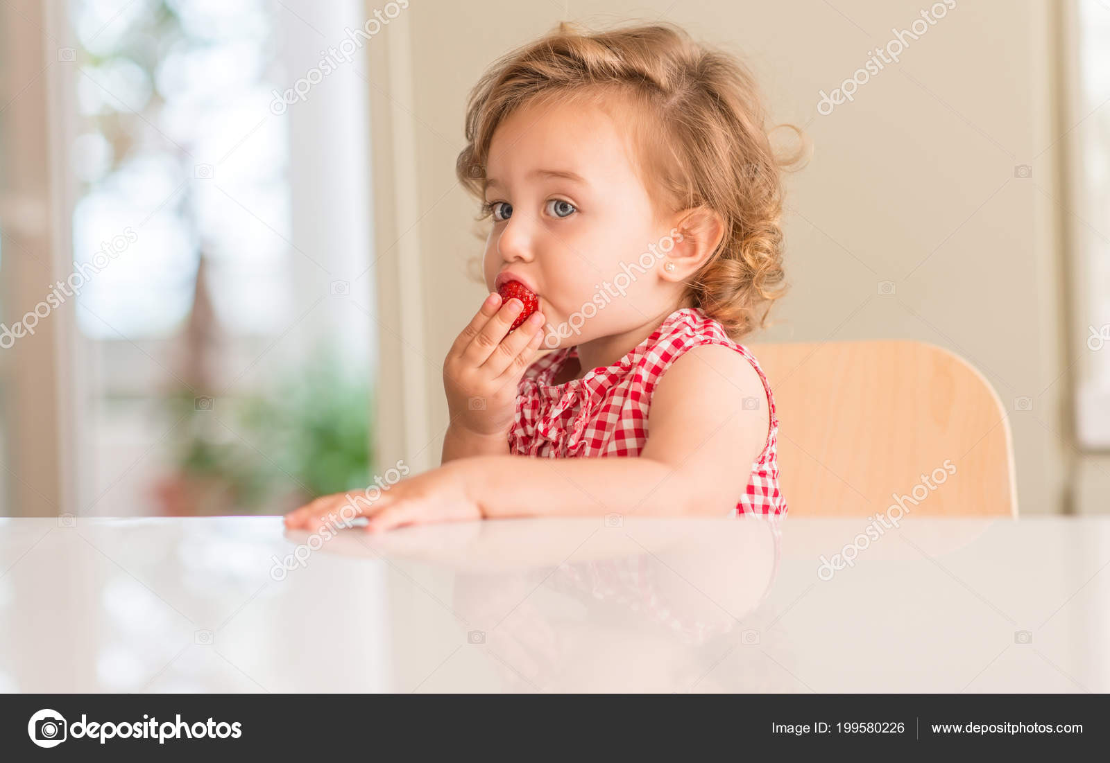 Beautiful Blonde Child Blue Eyes Eating Strawberry Home Stock