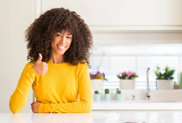 Африканская Американка Жёлтом Свитере Кухне Делает Счастливый Жест Вверх Рукой — стоковое фото