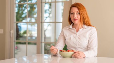 Ahududu evde ile acımak yüz ciddi düşünüyorum üstünde kendine güvenen bir ifade ile tahıl yemek Kızıl saçlı kadın