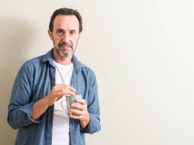 Komuta sizde ciddi düşünme akıllı yüzünde kendinden emin bir ifade ile bir kupa kahve içme