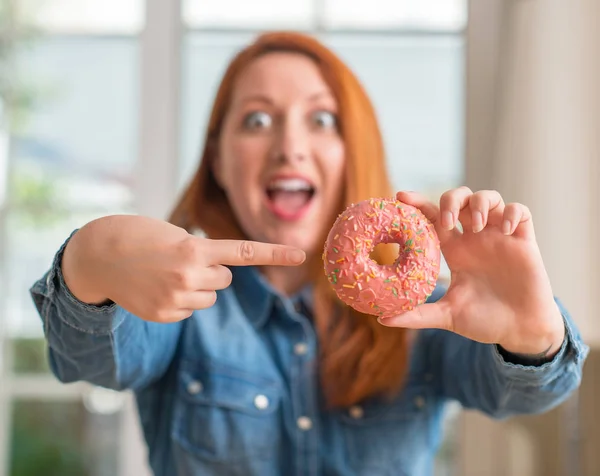 Redhead Woman Holding Donut Home Very Happy Pointing Hand Finger — Stock Photo, Image