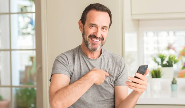 Middle Age Man Using Smartphone Surprise Face Pointing Finger Himself — Stock Photo, Image