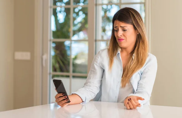 Disgusted Woman Using Smartphone Holding Mobile Phone Looking Home — Stock Photo, Image