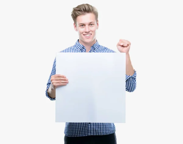 Young Handsome Blond Man Holding Banner Screaming Proud Celebrating Victory — Stock Photo, Image