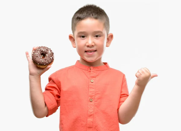 Dark Haired Little Child Eating Doughnut Pointing Hand Finger Happy — Stock Photo, Image