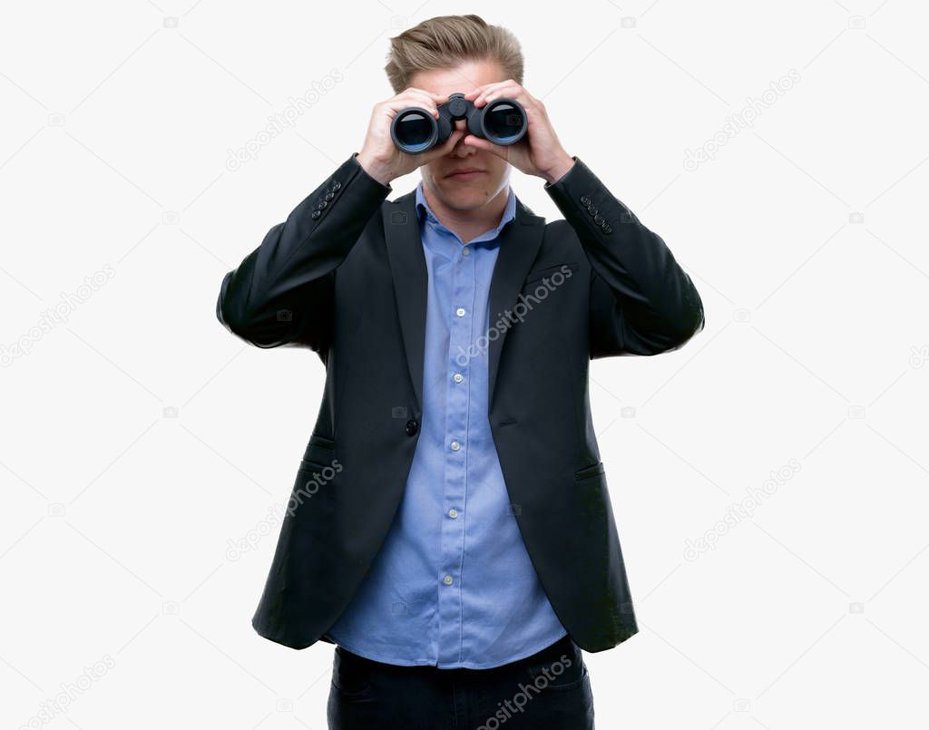 Young handsome blond man looking through binoculars with a confident expression on smart face thinking serious