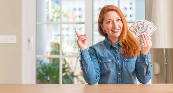 Redhead Woman Holding Dollar Bank Notes Home Very Happy Pointing — Stock Photo, Image