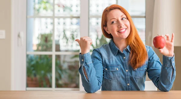 Redhead Woman Holding Red Apple Home Pointing Hand Finger Happy — Stock Photo, Image