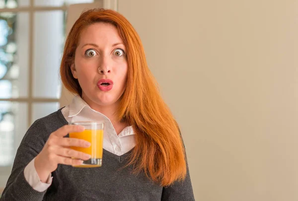 Redhead Woman Holding Orange Juice Glass Home Scared Shock Surprise — Stock Photo, Image