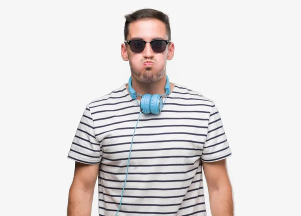 Handsome Young Man Wearing Headphones Puffing Cheeks Funny Face Mouth — Stock Photo, Image