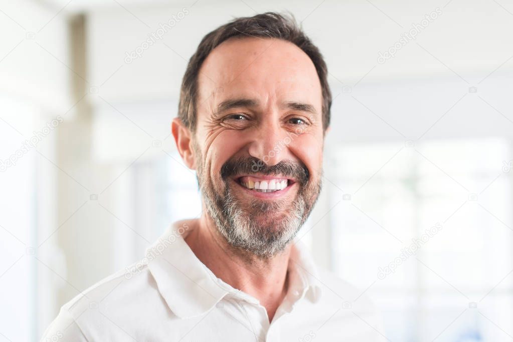 Handsome middle age man with a happy face standing and smiling with a confident smile showing teeth