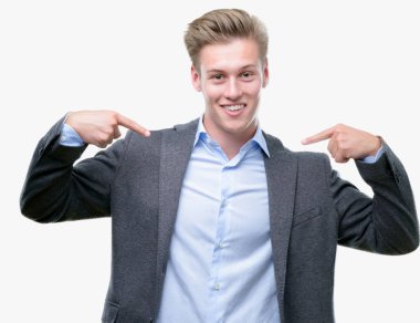 Yüzünde gülümseme ile kendinden emin görünüyorsun, kendini gururlu ve mutlu parmakları ile işaret genç yakışıklı sarışın iş adamı.