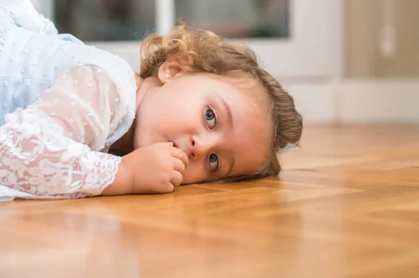 Beatiful Blond Child Laying Floor Hand Mouth Home — Stock Photo, Image