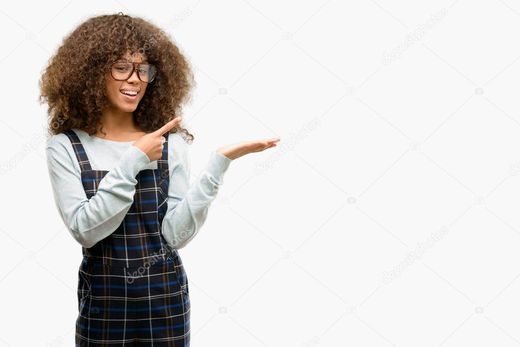African american woman wearing a retro style very happy pointing with hand and finger