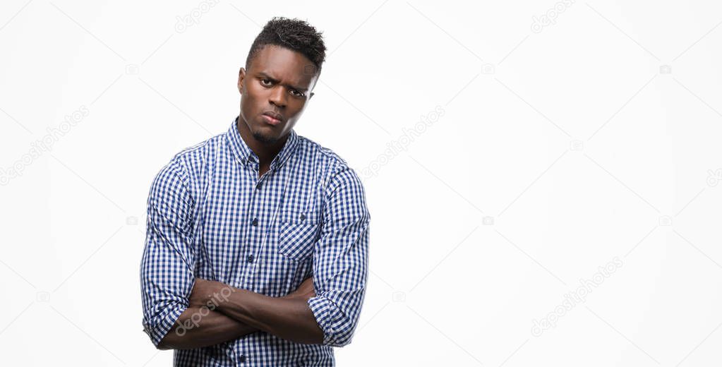 Young african american man wearing blue shirt skeptic and nervous, disapproving expression on face with crossed arms. Negative person.
