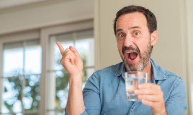 Bir bardak su ile el ve parmak tarafına işaret çok mutlu içme orta yaş erkek