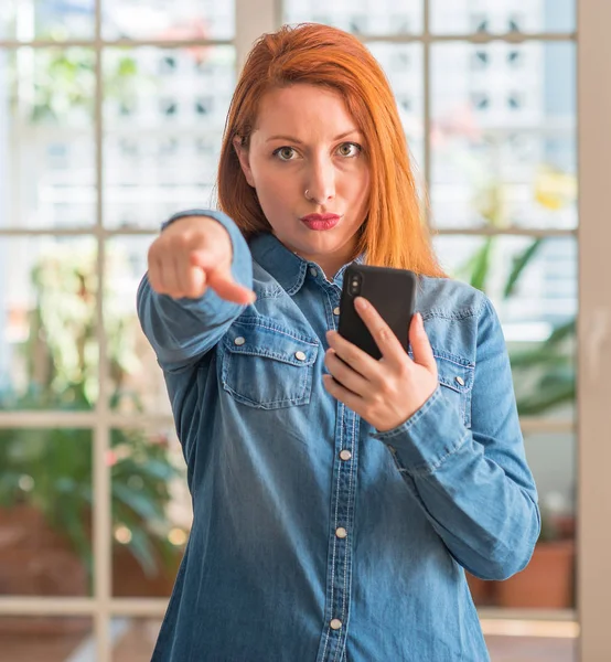 Donna Rossa Utilizzando Smartphone Casa Punta Con Dito Verso Fotocamera — Foto Stock