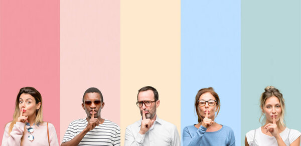 Mixed group of people, women and men with index finger on lips, ask to be quiet. Silence and secret concept