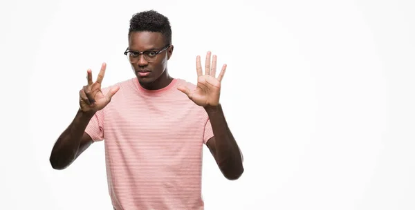 Young African American Man Wearing Pink Shirt Showing Pointing Fingers — Stock Photo, Image