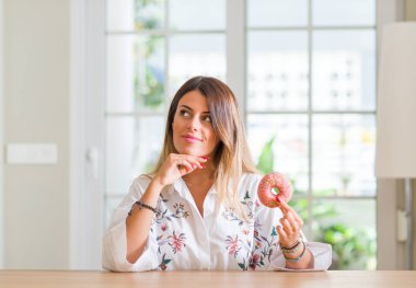Genç kadın evde yemek bir soru hakkında halka ciddi bir yüz düşünme, çok karışık bir fikir