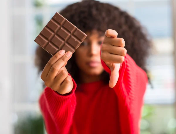 自宅の怒った顔 不承諾と負の符号を示す嫌い 拒絶反応の概念のチョコレート バーを食べるアフリカ系アメリカ人の女性 — ストック写真