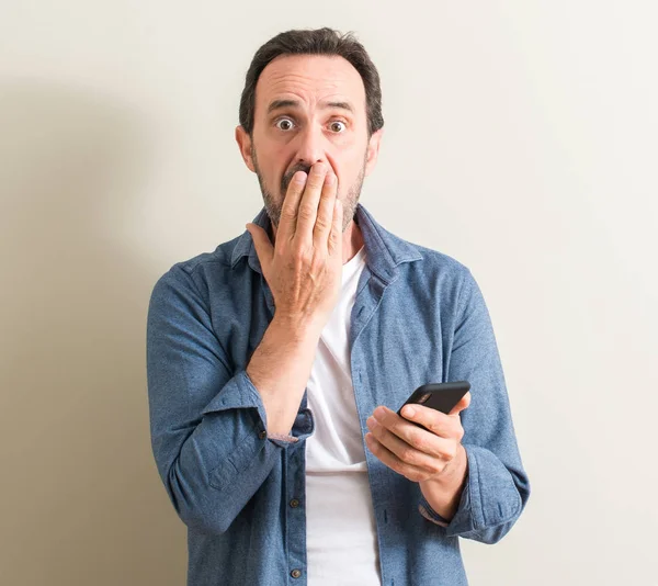 Senior Man Using Smartphone Cover Mouth Hand Shocked Shame Mistake — Stock Photo, Image