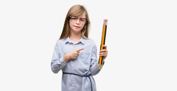 Young Blonde Child Holding Big Pencil Very Happy Pointing Hand — Stock Photo, Image