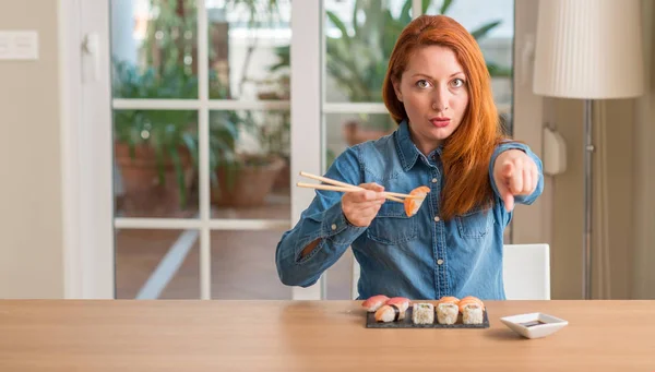 Redhead Woman Eating Sushi Using Chopsticks Pointing Finger Camera You — Stock Photo, Image