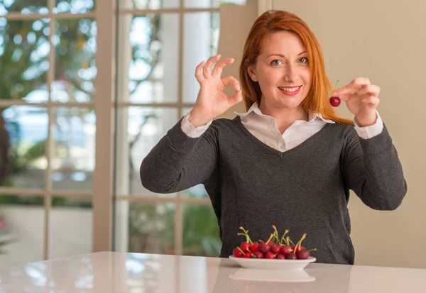 Redhead Woman Eating Cherries Home Doing Sign Fingers Excellent Symbol — Stock Photo, Image