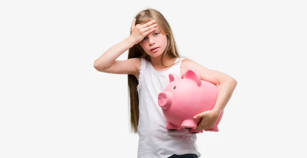 Young Blonde Toddler Holding Piggy Bank Stressed Hand Head Shocked — Stock Photo, Image