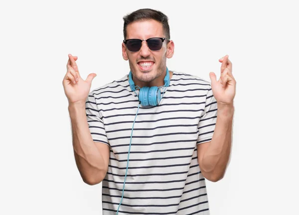 Handsome Young Man Wearing Headphones Smiling Crossing Fingers Hope Eyes — Stock Photo, Image