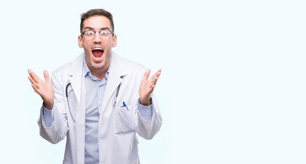 Handsome Young Doctor Man Celebrating Crazy Amazed Success Arms Raised — Stock Photo, Image